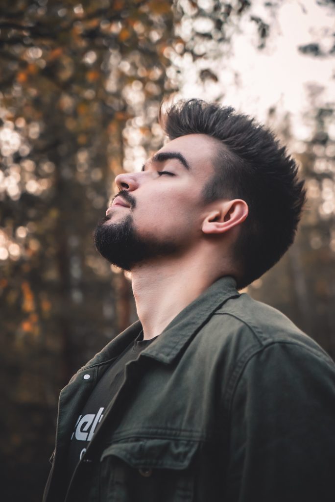 Man with raised head breathing in