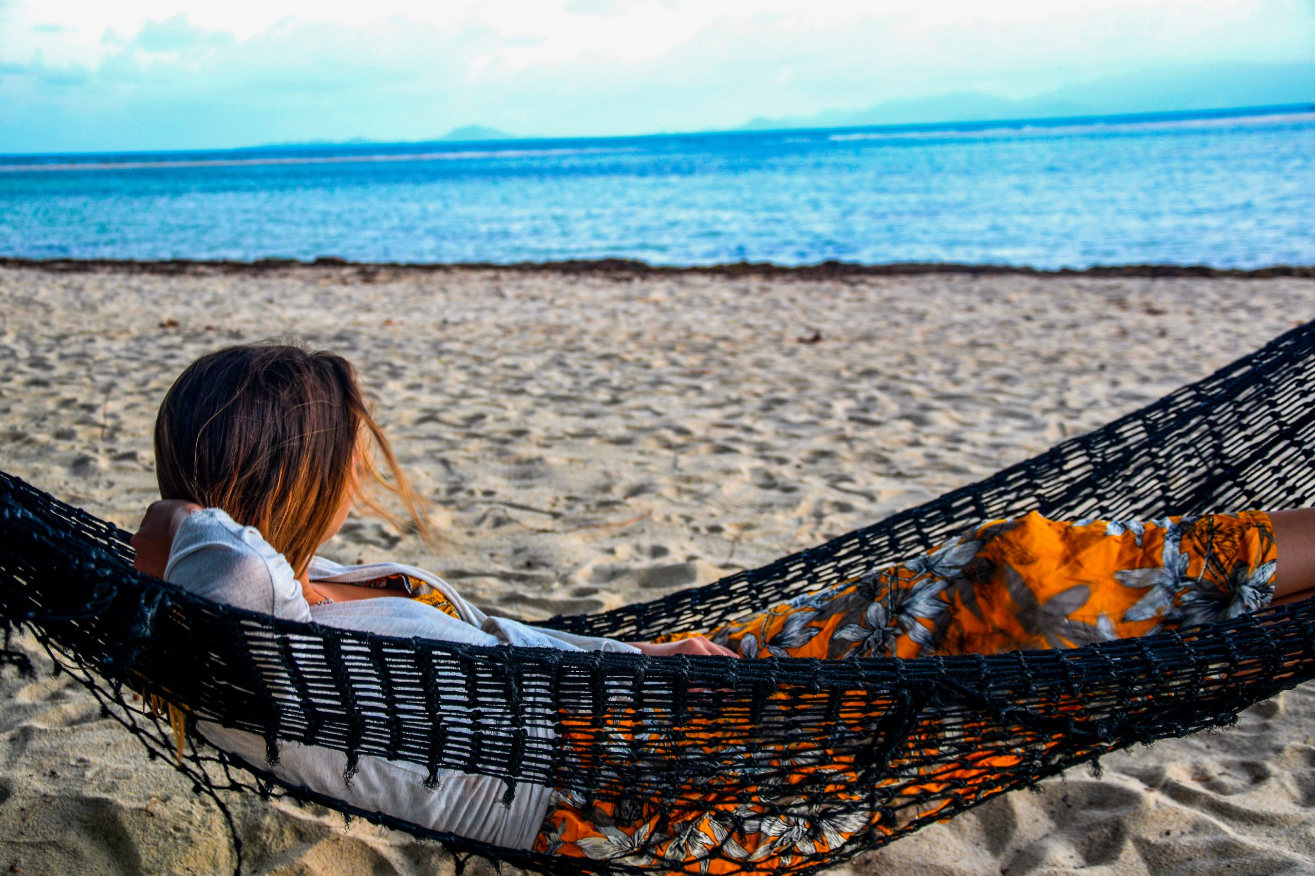 Women relaxing in a hammock on beach