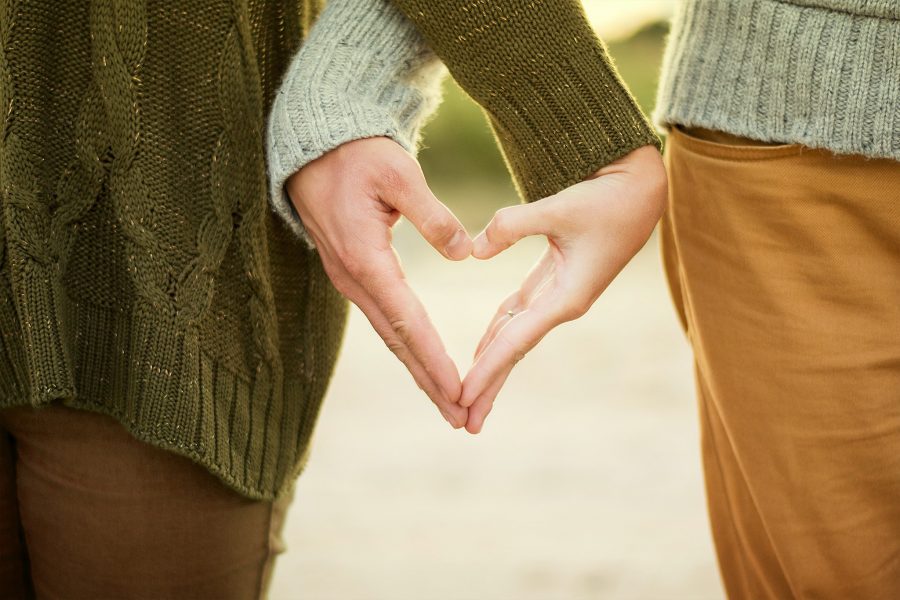 Couple holding hands in heart shape